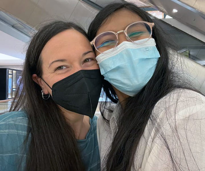 Dr. Erin Meyer and Nesha Ichida both wearing masks and smiling while posing for a selfie.