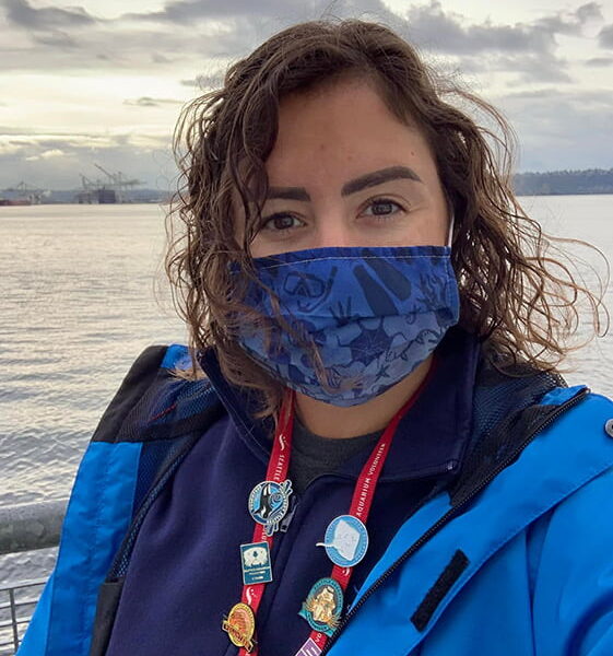 Seattle Aquarium volunteer Whitney Golay posing for a portrait in front of Elliot Bay.