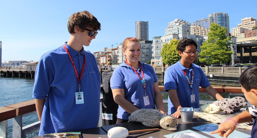 Three volunteers smiling.