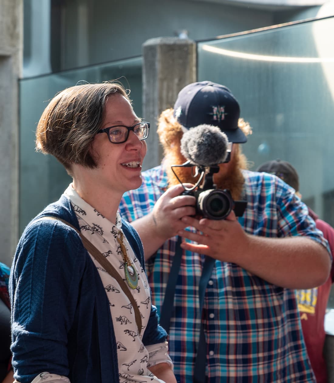 Grace Freeman speaking. A photographer stands behind her.