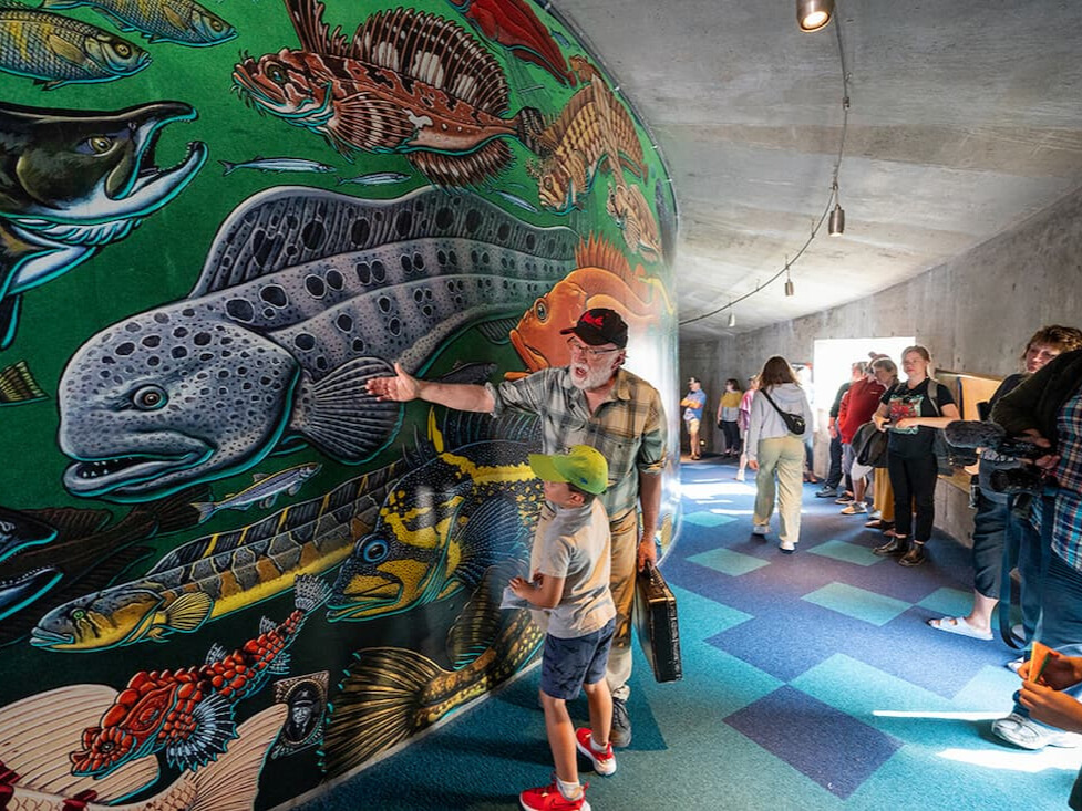 Artist Ray Troll at the Aquarium's September 2023 dedication of his new Aquarium mural “Salish Seascape.”