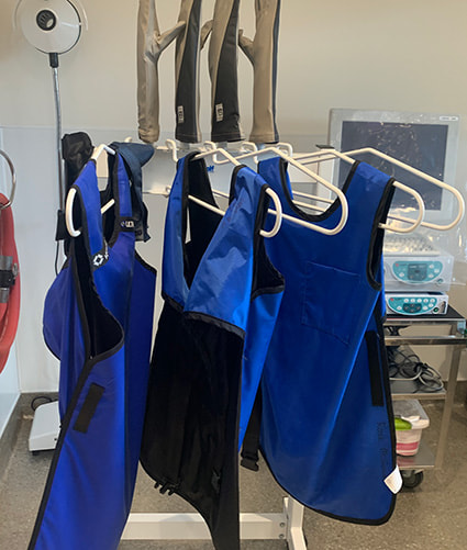 Three led gowns hanging from clothing hangers.
