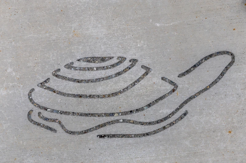 Etching representing a clam, part of the Indigenous art etched into the pavement of the rooftop on the Ocean Pavilion.