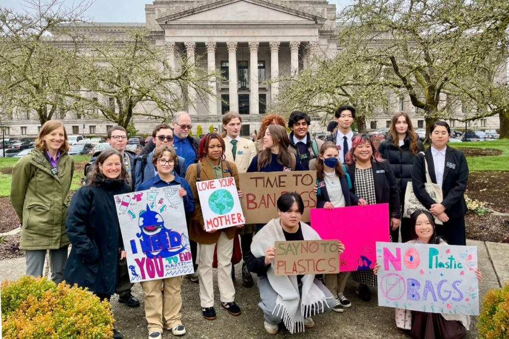 Youth Ocean Advocates holding signs in front of the Capitol Building.