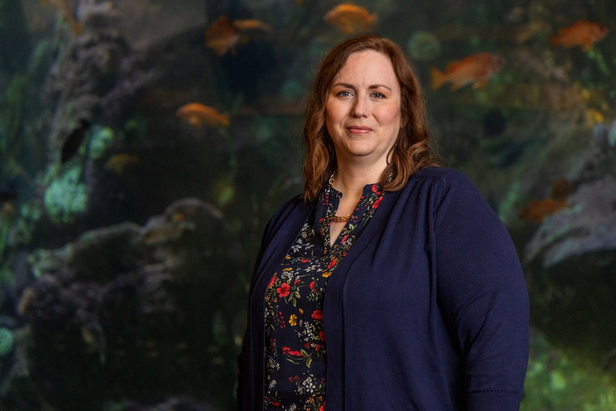 April Henderson standing in front of the Window on Washington Waters habitat.